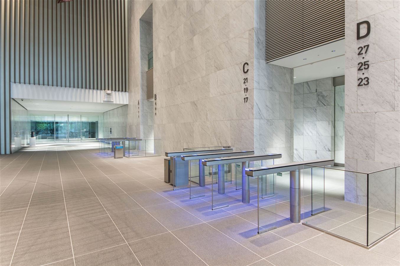UG series gates with blue LED floor lighting in a marble lobby